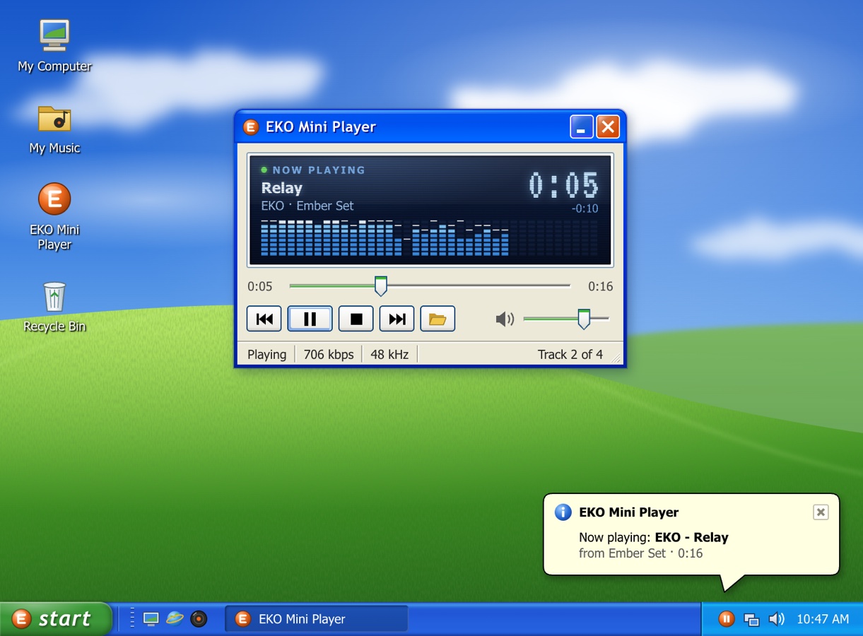 EKO Mini Player on a rolling-hills desktop, with a now-playing tray balloon